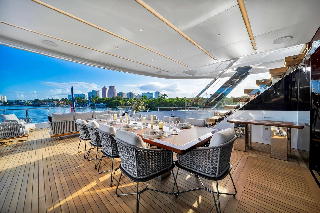 The aft deck features an elegant dining area with a stunning view of the water. aboard BAGLIETTO DOM 133 #5 Yacht for Sale