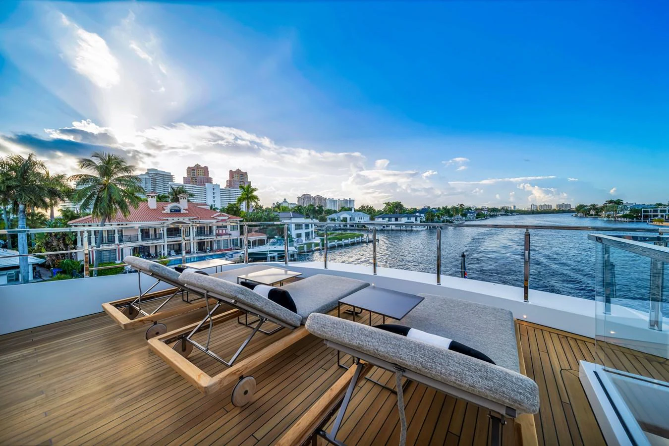 The sundeck offers a serene space with sun loungers and a stunning waterfront view. aboard BAGLIETTO DOM 133 #5 Yacht for Sale