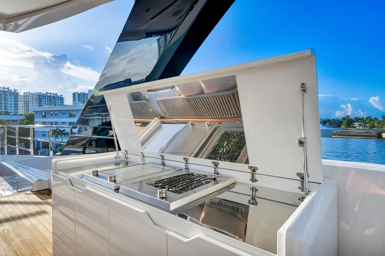 The yacht features a sleek outdoor galley with modern appliances and a stunning waterfront view. aboard BAGLIETTO DOM 133 #5 Yacht for Sale