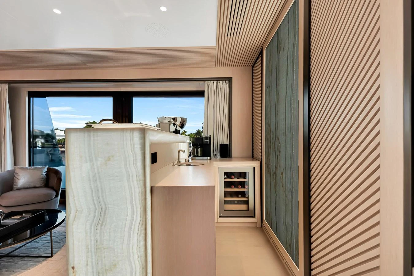 The yacht's interior features a modern design with sleek cabinetry and a small wine cooler. aboard BAGLIETTO DOM 133 #5 Yacht for Sale