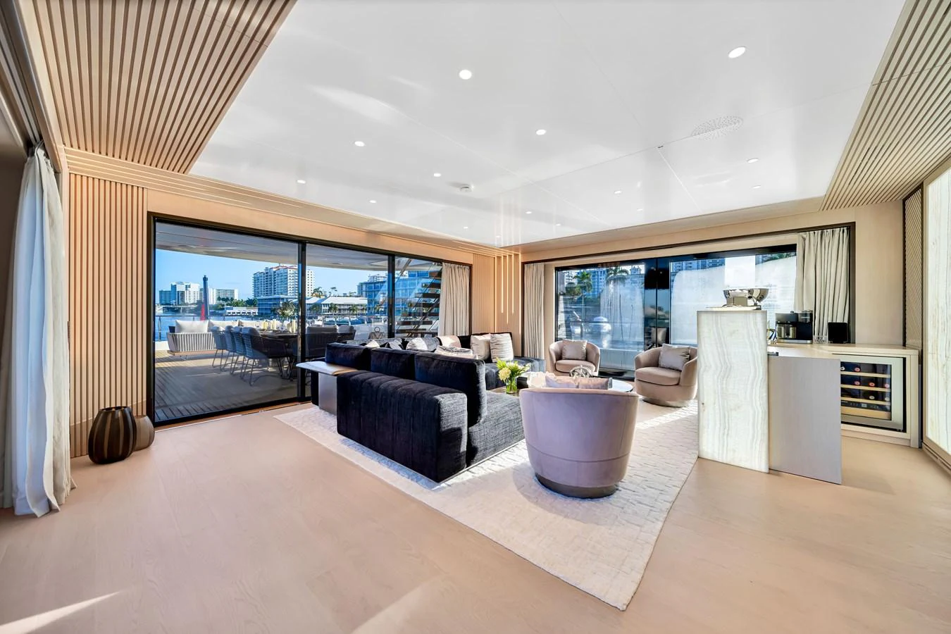 The spacious salon features modern furnishings and large windows offering panoramic views. aboard BAGLIETTO DOM 133 #5 Yacht for Sale