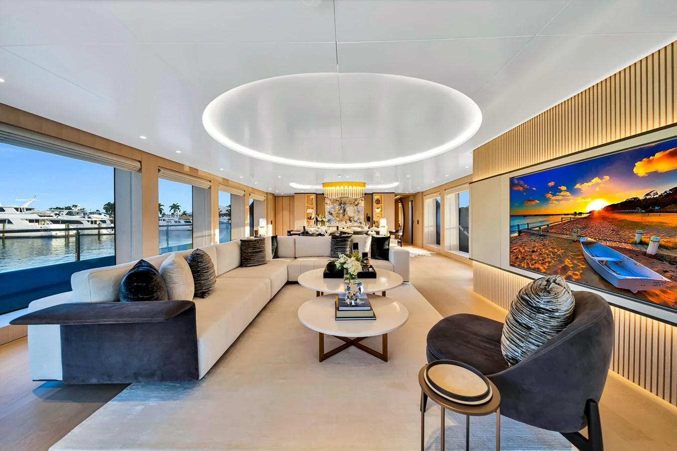 The yacht's salon features luxurious seating, a large flat-screen TV, and elegant decor with ample natural light. aboard BAGLIETTO DOM 133 #5 Yacht for Sale