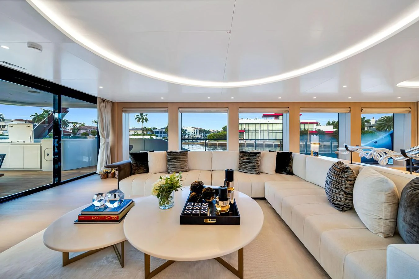 The spacious salon features a large, comfortable seating area with panoramic windows offering stunning views. aboard BAGLIETTO DOM 133 #5 Yacht for Sale