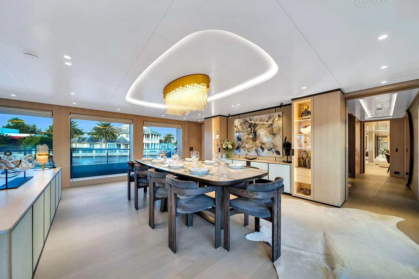 The yacht's dining area features a luxurious table setting with a stunning chandelier and elegant decor. aboard BAGLIETTO DOM 133 #5 Yacht for Sale