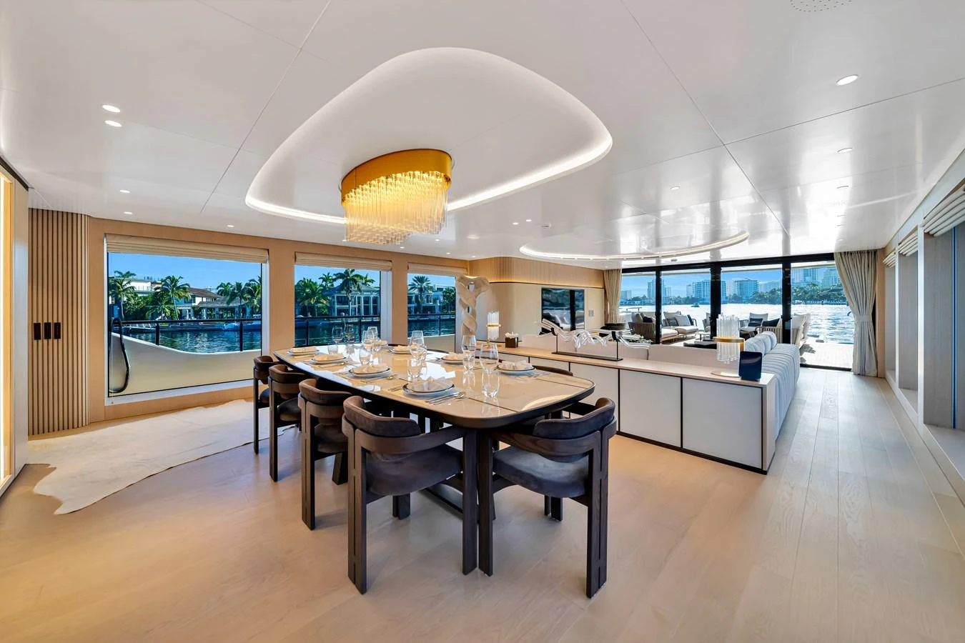 The spacious salon features a luxurious dining area with panoramic windows offering stunning views. aboard BAGLIETTO DOM 133 #5 Yacht for Sale