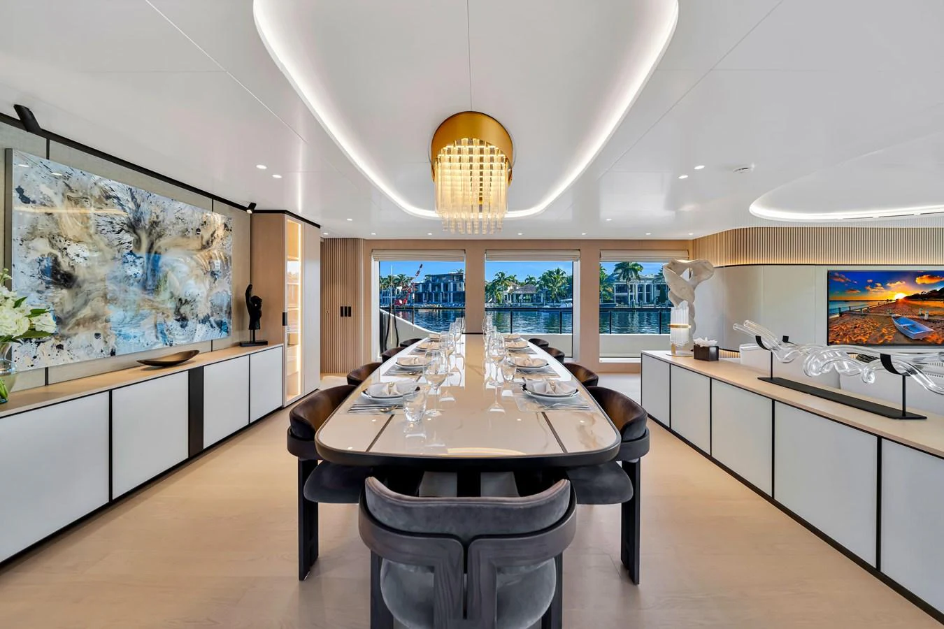 The yacht's dining area features a sleek, modern design with a large table and elegant lighting. aboard BAGLIETTO DOM 133 #5 Yacht for Sale