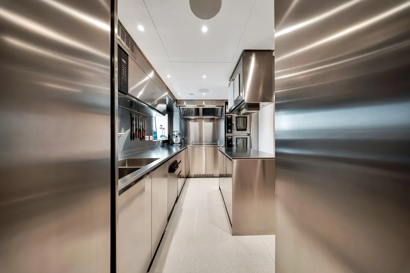 The yacht's galley is equipped with modern stainless steel appliances and ample counter space. aboard BAGLIETTO DOM 133 #5 Yacht for Sale