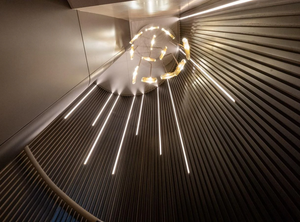 A modern and artistic lighting fixture illuminates the yacht's interior with a sleek, contemporary design. aboard BAGLIETTO DOM 133 #5 Yacht for Sale