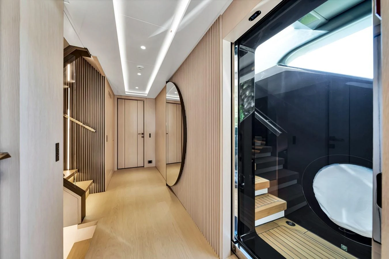 The yacht's interior features a sleek hallway with modern design elements and a staircase leading to another level. aboard BAGLIETTO DOM 133 #5 Yacht for Sale