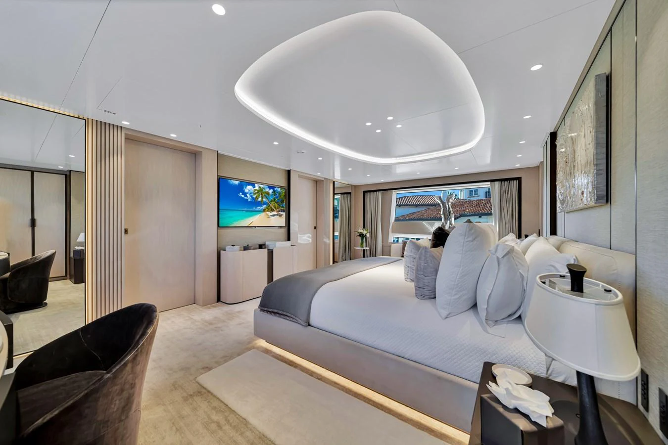 The master stateroom features a luxurious bed, modern lighting, and a large flat-screen TV. aboard BAGLIETTO DOM 133 #5 Yacht for Sale