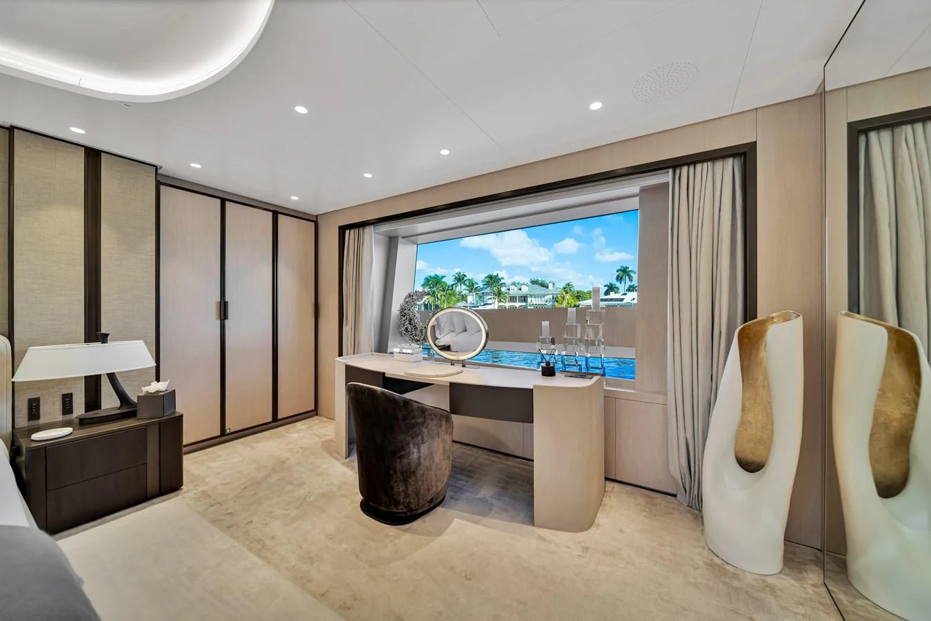 A luxurious stateroom with a large window offering a stunning view of the water. aboard BAGLIETTO DOM 133 #5 Yacht for Sale