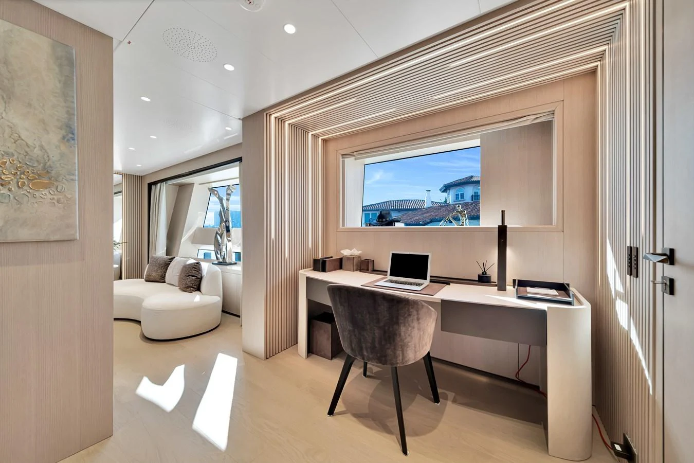 This luxurious yacht office features modern furnishings and a large window with a stunning view. aboard BAGLIETTO DOM 133 #5 Yacht for Sale