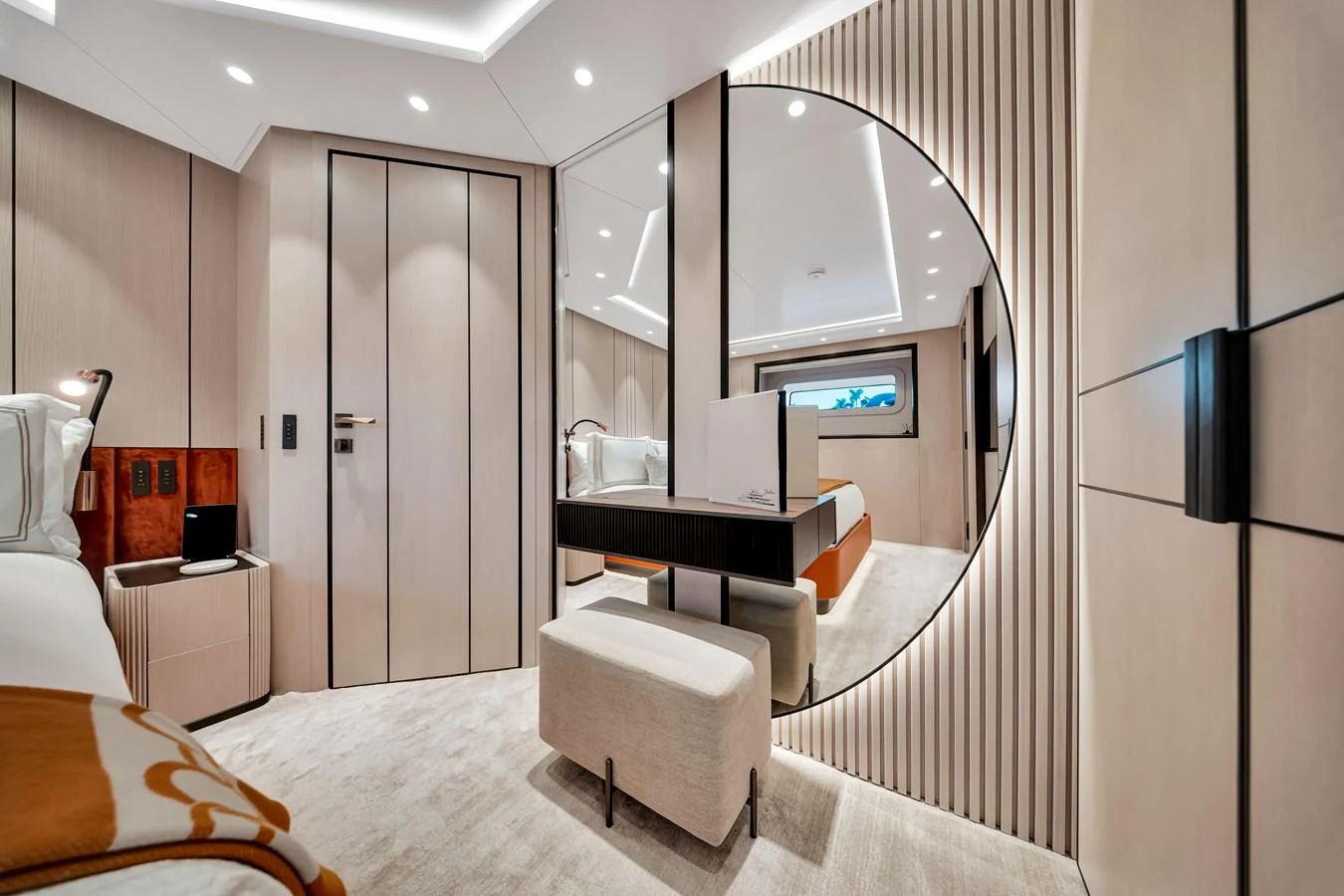 The stateroom features modern decor with a large circular mirror and elegant lighting. aboard BAGLIETTO DOM 133 #5 Yacht for Sale