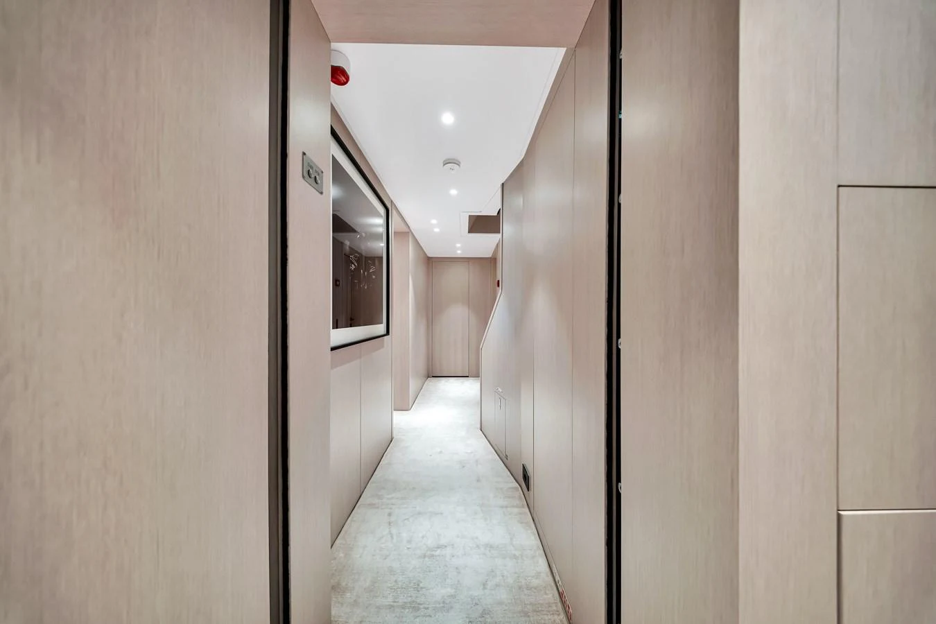 A sleek and modern hallway with light wood paneling and recessed lighting. aboard BAGLIETTO DOM 133 #5 Yacht for Sale