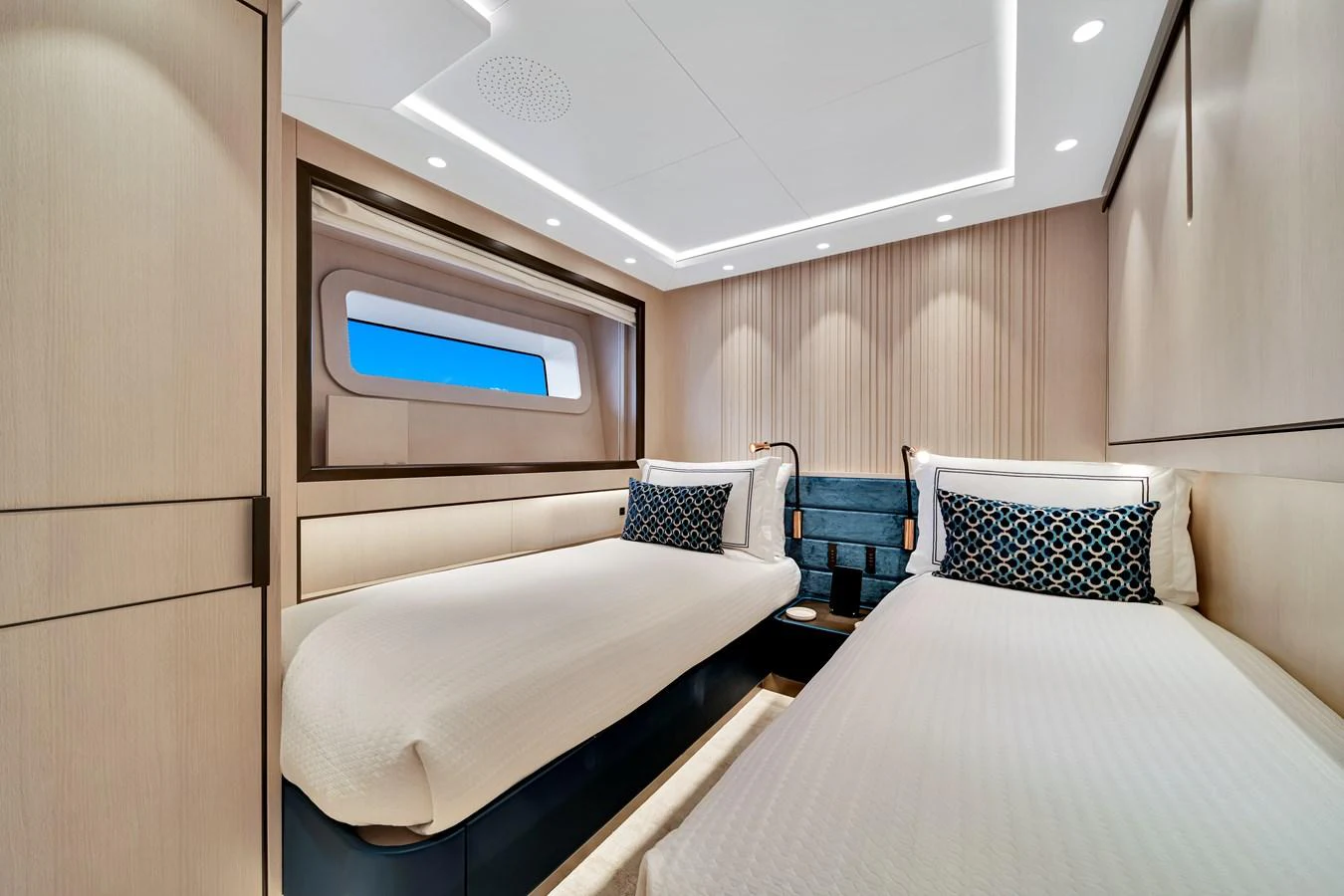 A modern twin stateroom featuring sleek design and comfortable bedding. aboard BAGLIETTO DOM 133 #5 Yacht for Sale