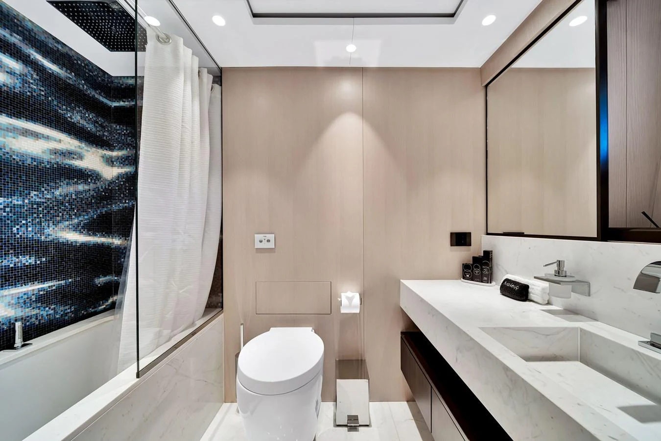 The yacht's bathroom features modern fixtures and a sleek design with a combination of light wood and white surfaces. aboard BAGLIETTO DOM 133 #5 Yacht for Sale