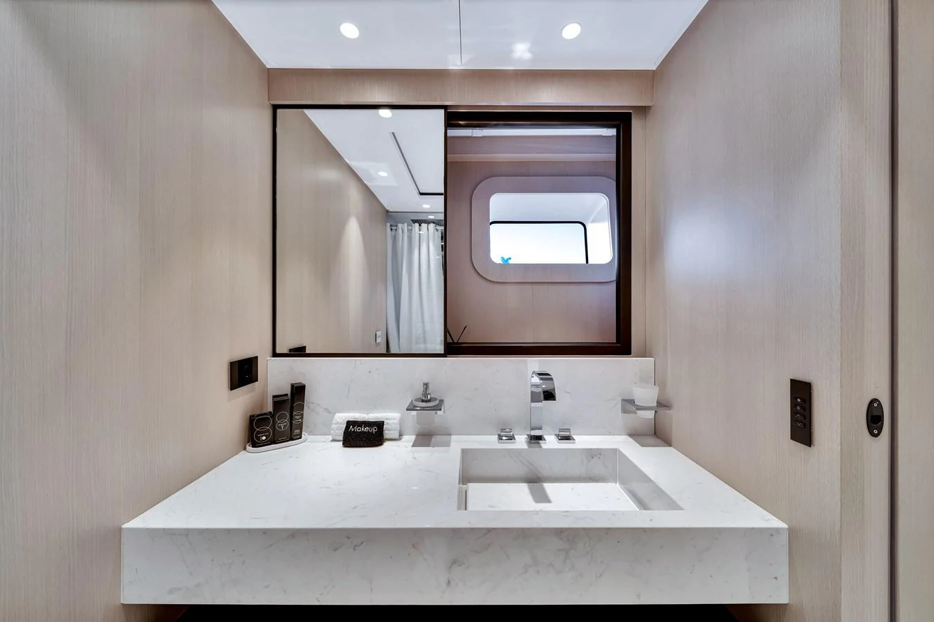 The yacht's bathroom features a sleek, modern design with a marble countertop and a large mirror. aboard BAGLIETTO DOM 133 #5 Yacht for Sale