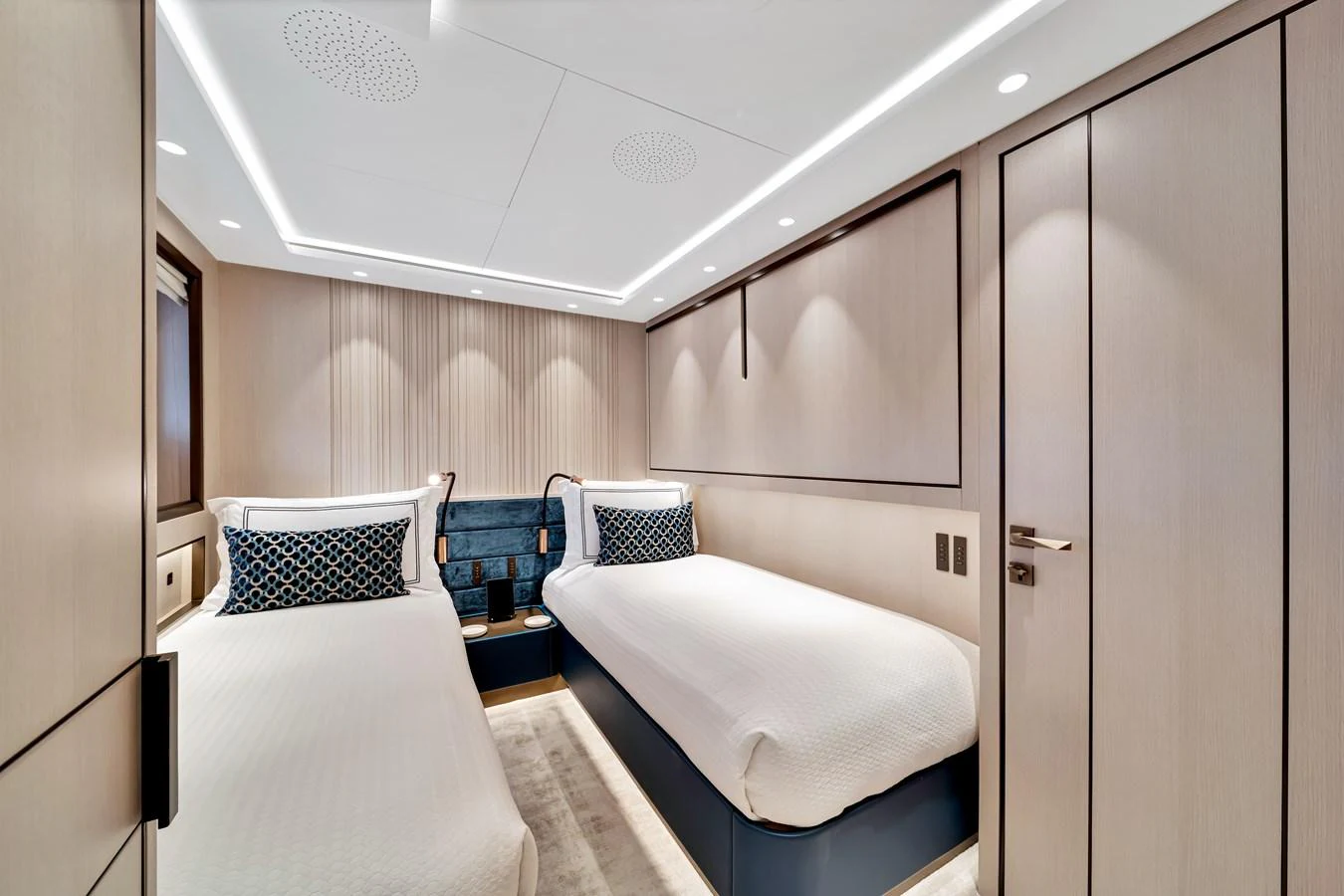 The guest stateroom features twin beds with elegant bedding and modern lighting. aboard BAGLIETTO DOM 133 #5 Yacht for Sale