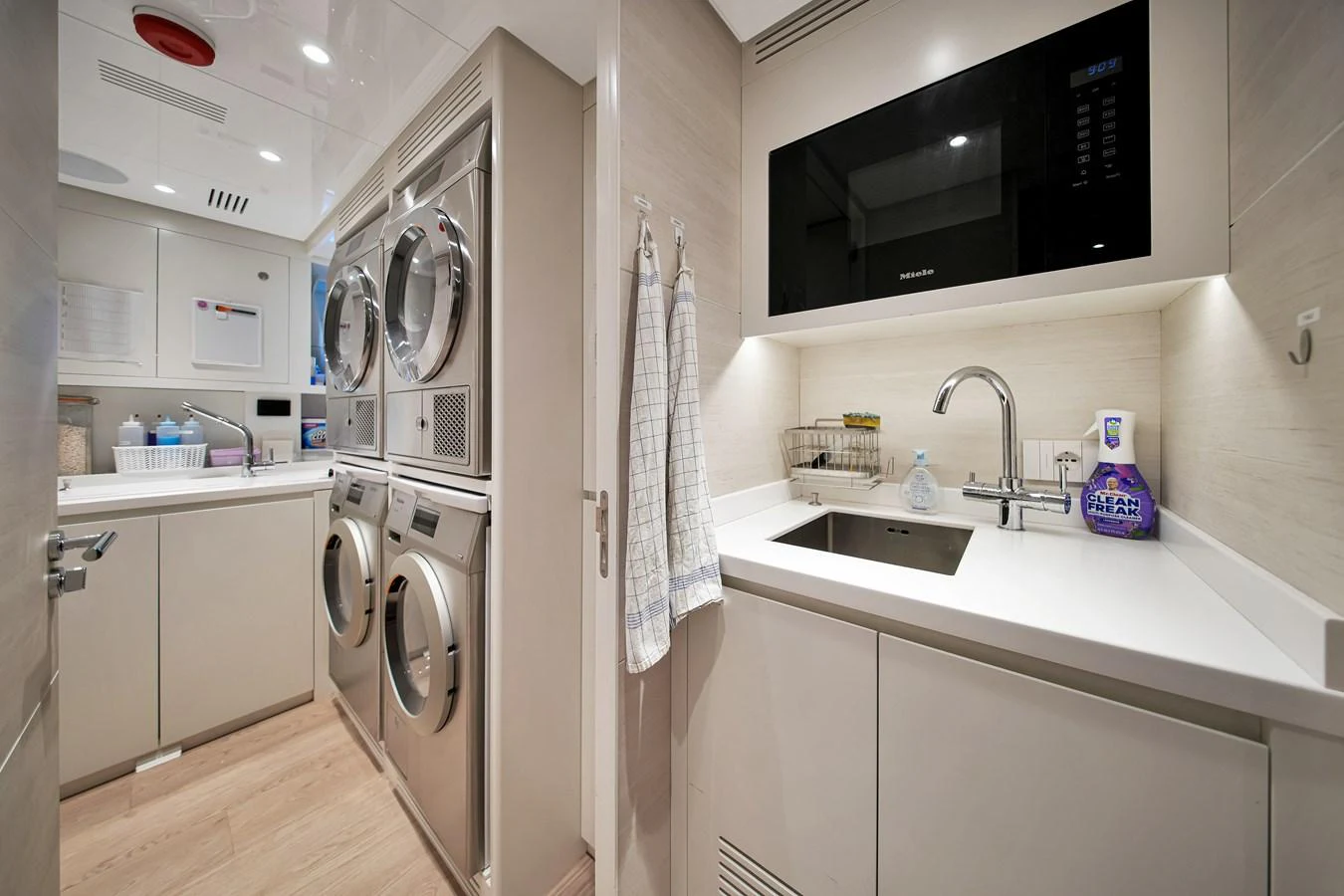 The yacht's laundry room is equipped with modern appliances and a sleek sink area. aboard BAGLIETTO DOM 133 #5 Yacht for Sale