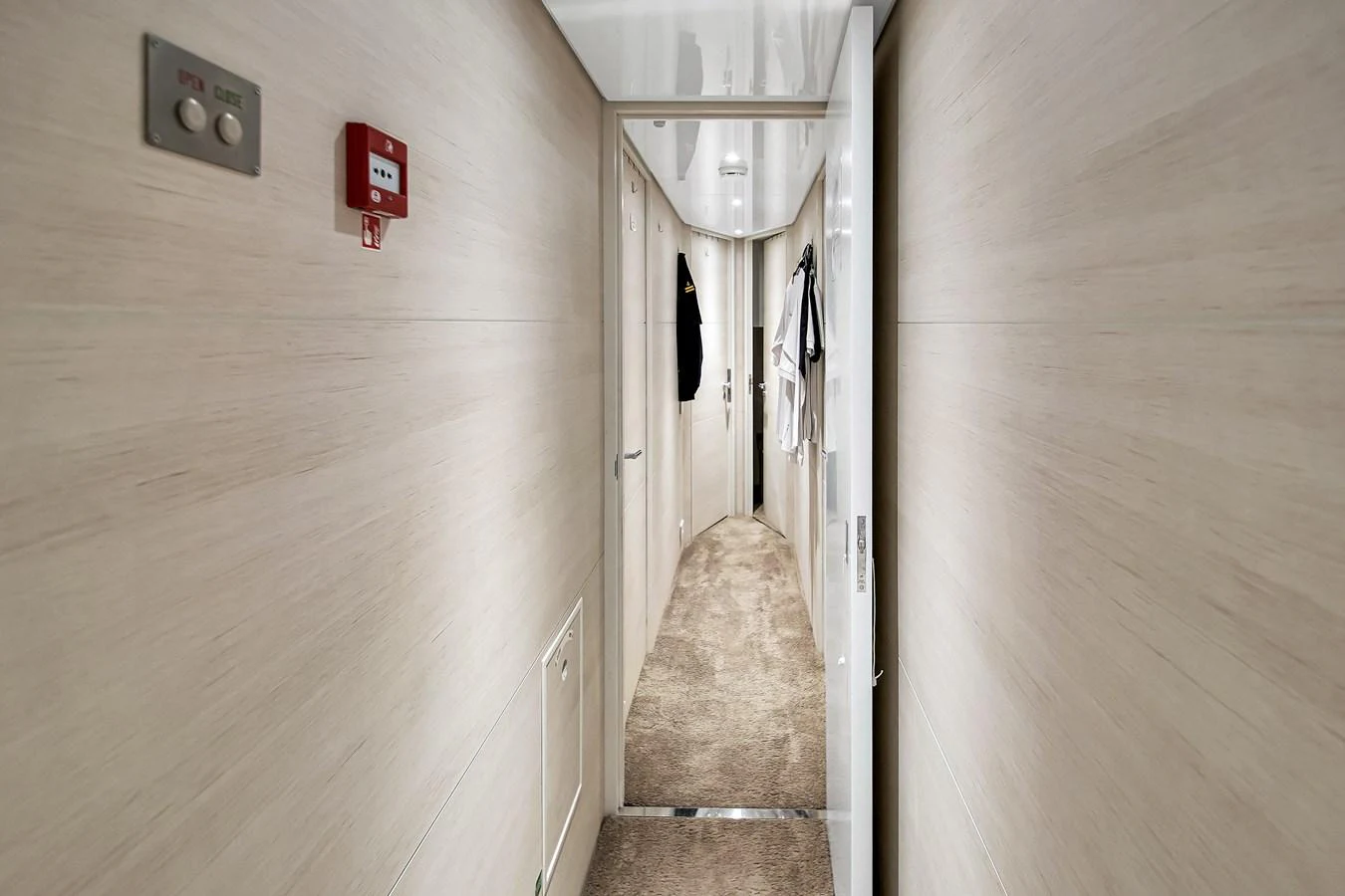 A sleek and modern hallway with light wood paneling and plush carpeting. aboard BAGLIETTO DOM 133 #5 Yacht for Sale