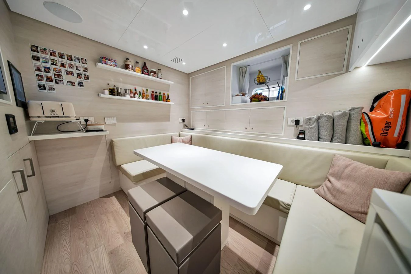A cozy galley area with a dining table and seating, perfect for casual meals and relaxation. aboard BAGLIETTO DOM 133 #5 Yacht for Sale