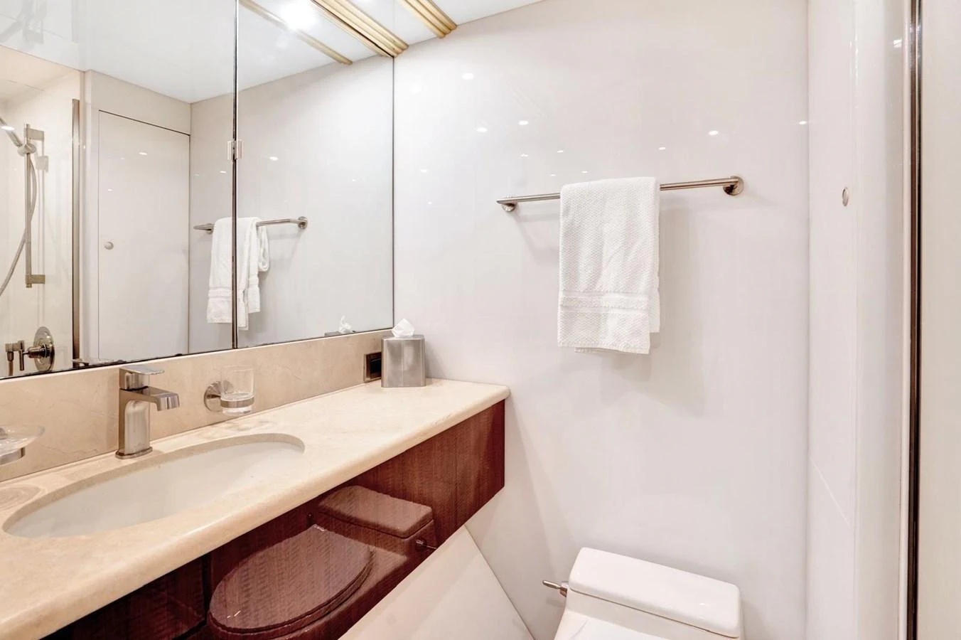 The yacht's bathroom features a sleek design with modern fixtures and ample lighting. aboard TRANQUILITY IV - 94 FT LAZZARA MOTORYACHT 2001 Yacht for Sale