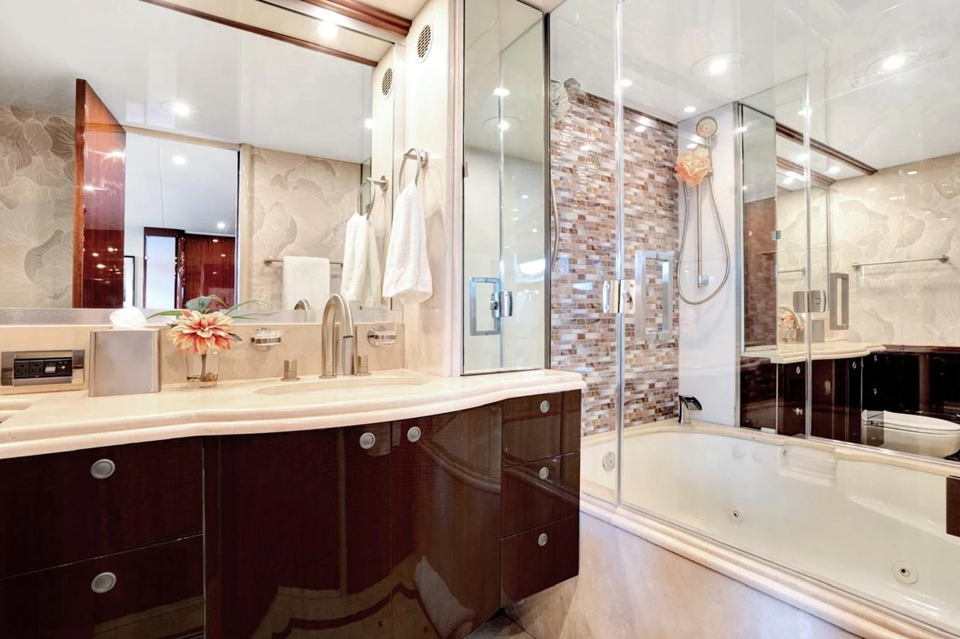 The yacht's bathroom features a luxurious design with modern fixtures and a spacious shower area. aboard TRANQUILITY IV - 94 FT LAZZARA MOTORYACHT 2001 Yacht for Sale