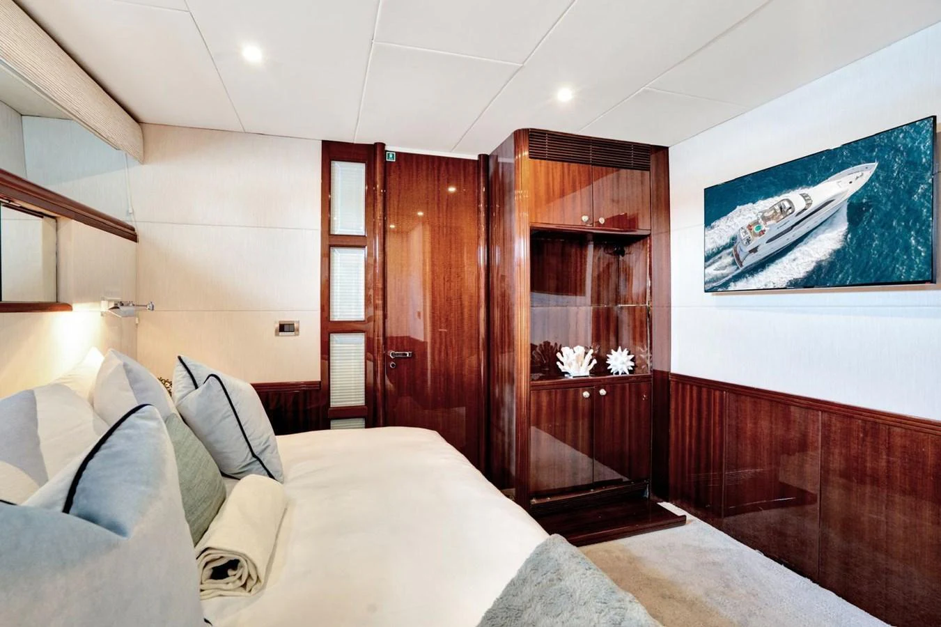 A luxurious stateroom featuring elegant wood finishes and plush bedding. aboard TRANQUILITY IV - 94 FT LAZZARA MOTORYACHT 2001 Yacht for Sale