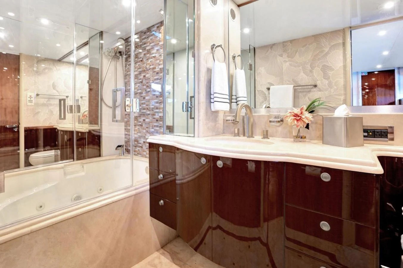 The yacht's bathroom features a luxurious design with elegant fixtures and ample lighting. aboard TRANQUILITY IV - 94 FT LAZZARA MOTORYACHT 2001 Yacht for Sale