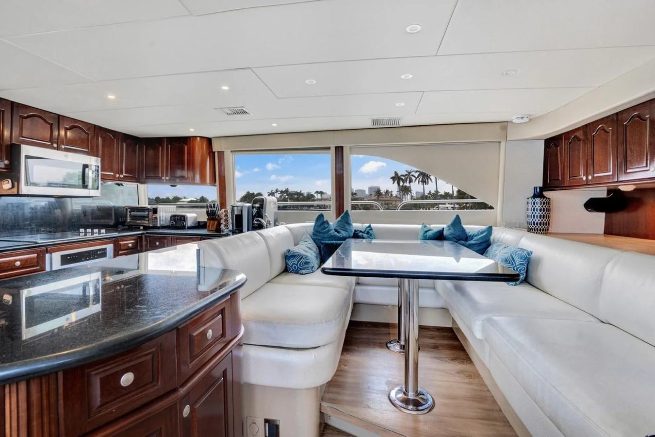 The saloon features a spacious seating area with a dining table and a well-equipped galley. aboard TRANQUILITY IV - 94 FT LAZZARA MOTORYACHT 2001 Yacht for Sale