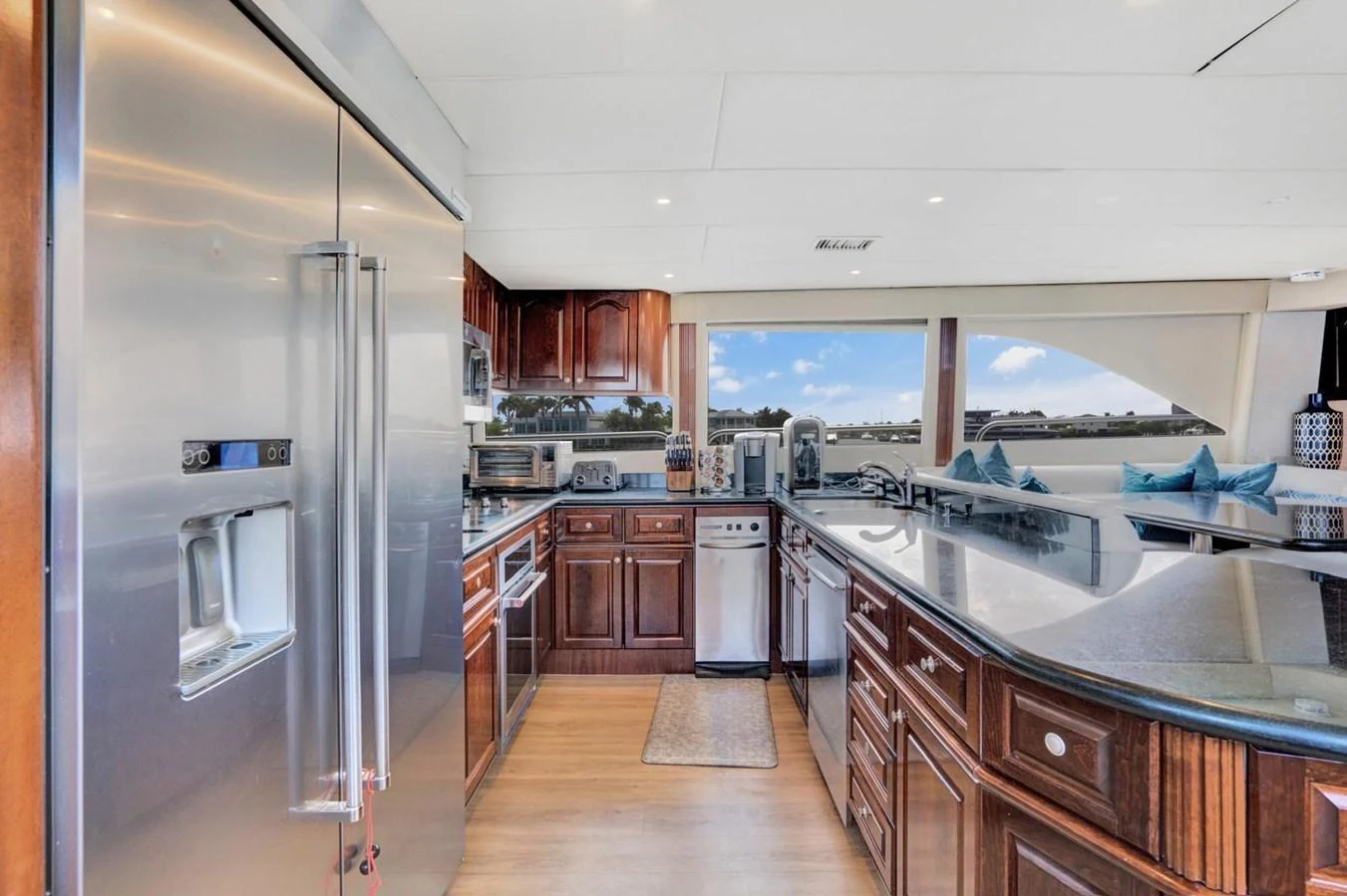 The yacht's galley features modern appliances and elegant wood cabinetry, providing a luxurious space for culinary activities. aboard TRANQUILITY IV - 94 FT LAZZARA MOTORYACHT 2001 Yacht for Sale