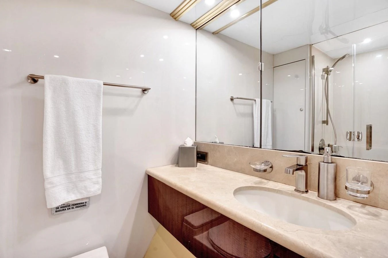 The yacht's bathroom features a sleek design with modern fixtures and ample lighting. aboard TRANQUILITY IV - 94 FT LAZZARA MOTORYACHT 2001 Yacht for Sale