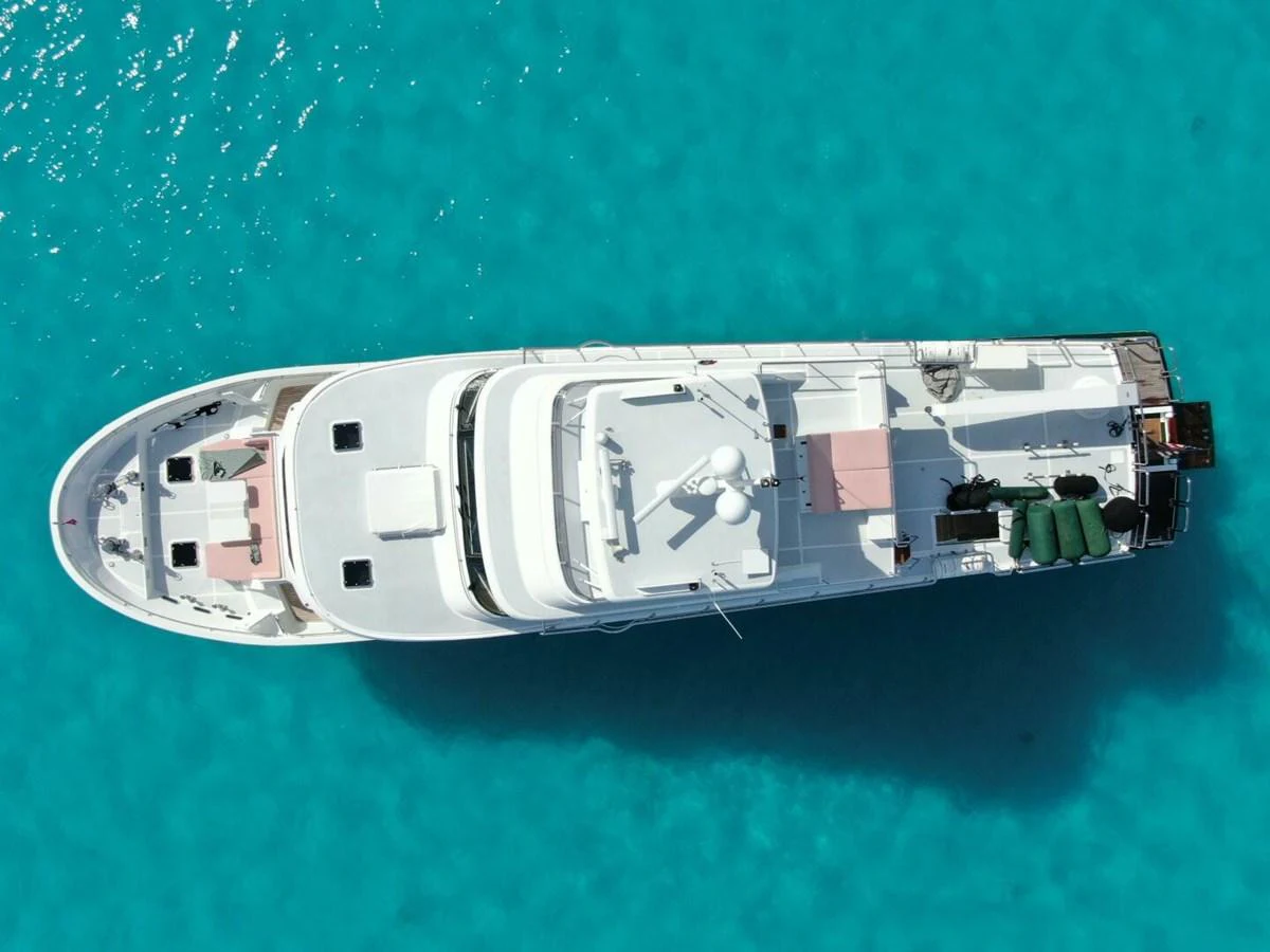 A stunning aerial view of a luxurious yacht cruising on crystal-clear turquoise waters. aboard ARTEMIS II Yacht for Sale