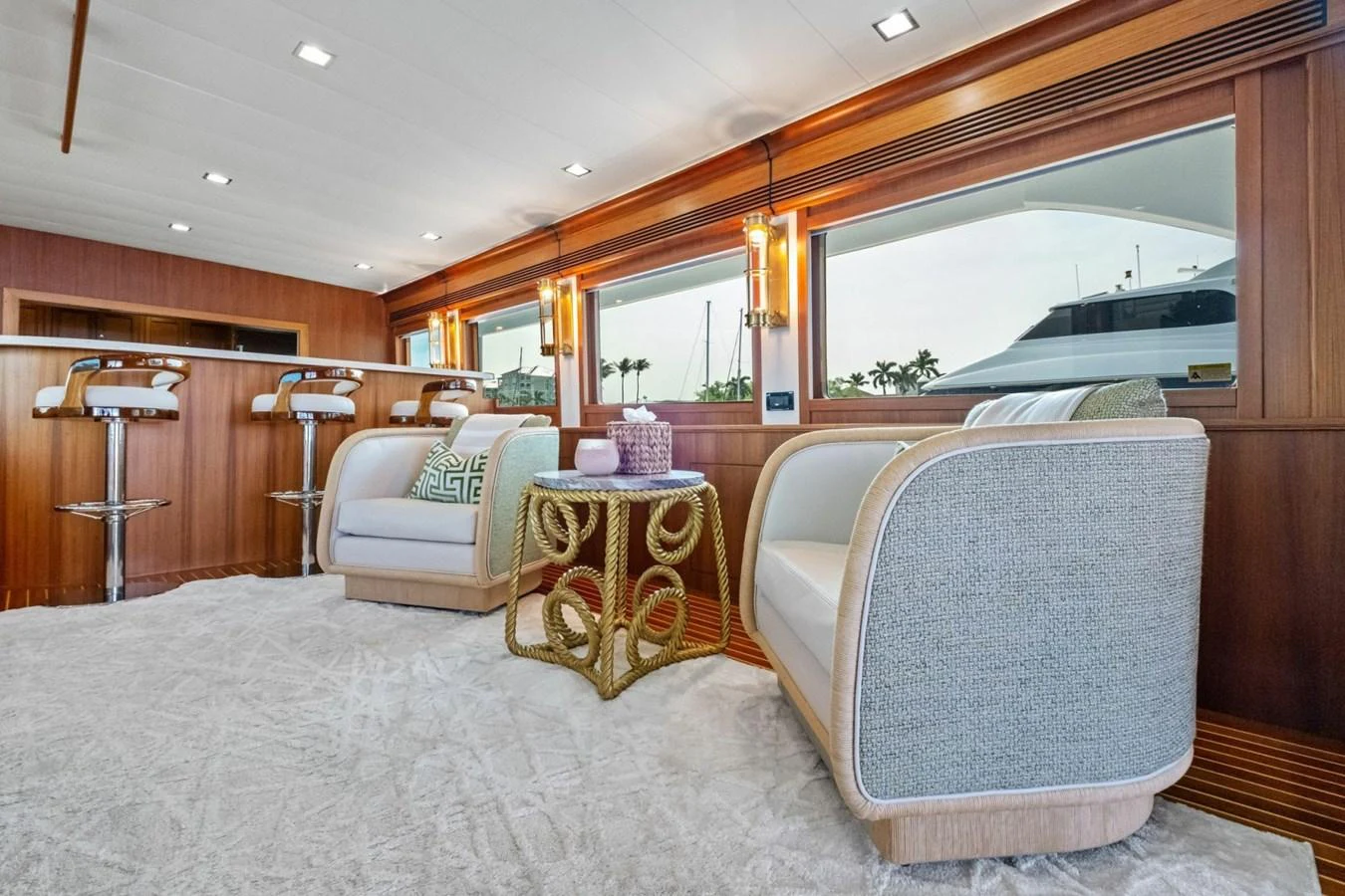 The salon features elegant seating with a view of the surrounding waters through large windows. aboard ARTEMIS II Yacht for Sale