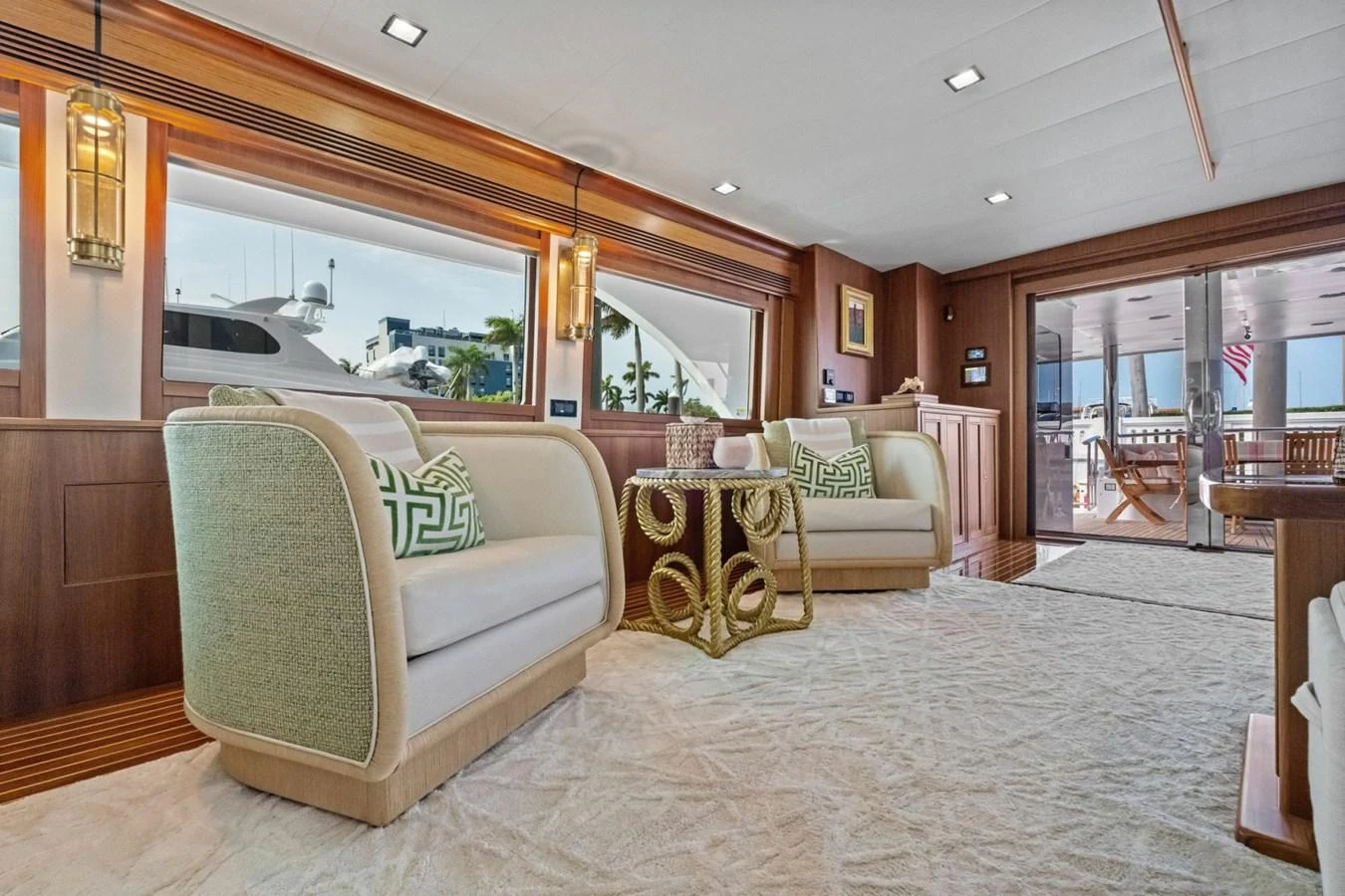 The salon features elegant seating with a view of the marina through large windows. aboard ARTEMIS II Yacht for Sale