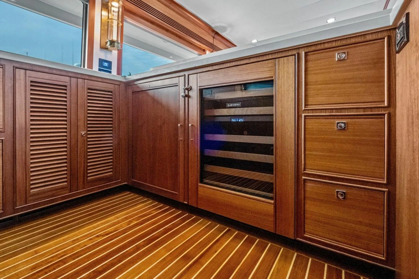 The yacht's galley features elegant wooden cabinetry and a built-in wine cooler. aboard ARTEMIS II Yacht for Sale