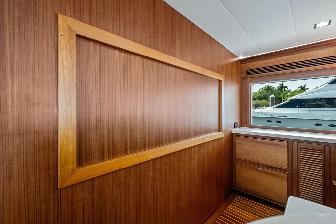 The interior features warm wood paneling and a view of the exterior through a window. aboard ARTEMIS II Yacht for Sale