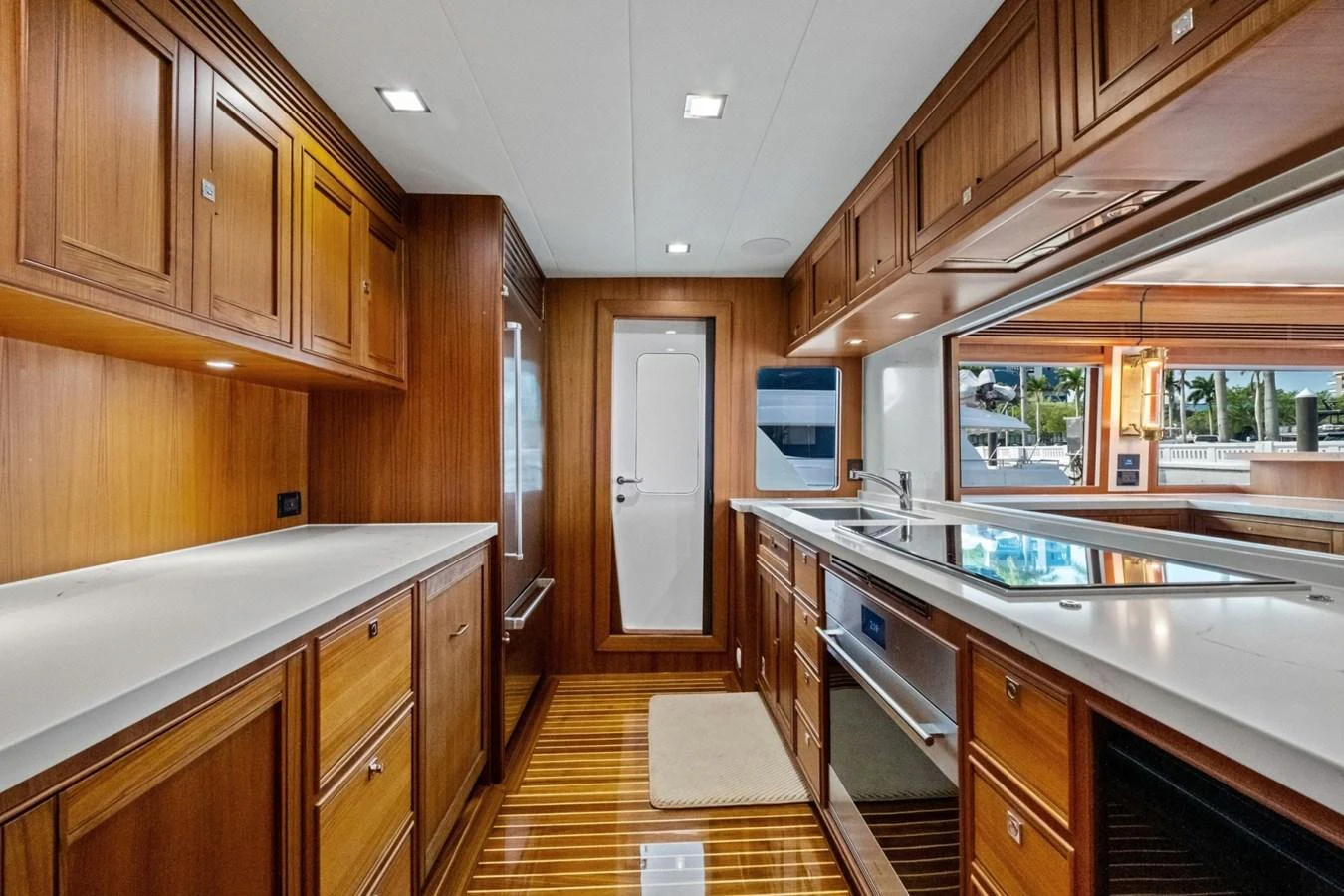 The yacht's galley features elegant wooden cabinetry and modern appliances, creating a warm and functional space. aboard ARTEMIS II Yacht for Sale