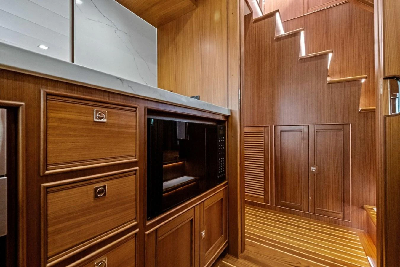 The yacht's galley features elegant wooden cabinetry and modern appliances, creating a warm and functional space. aboard ARTEMIS II Yacht for Sale