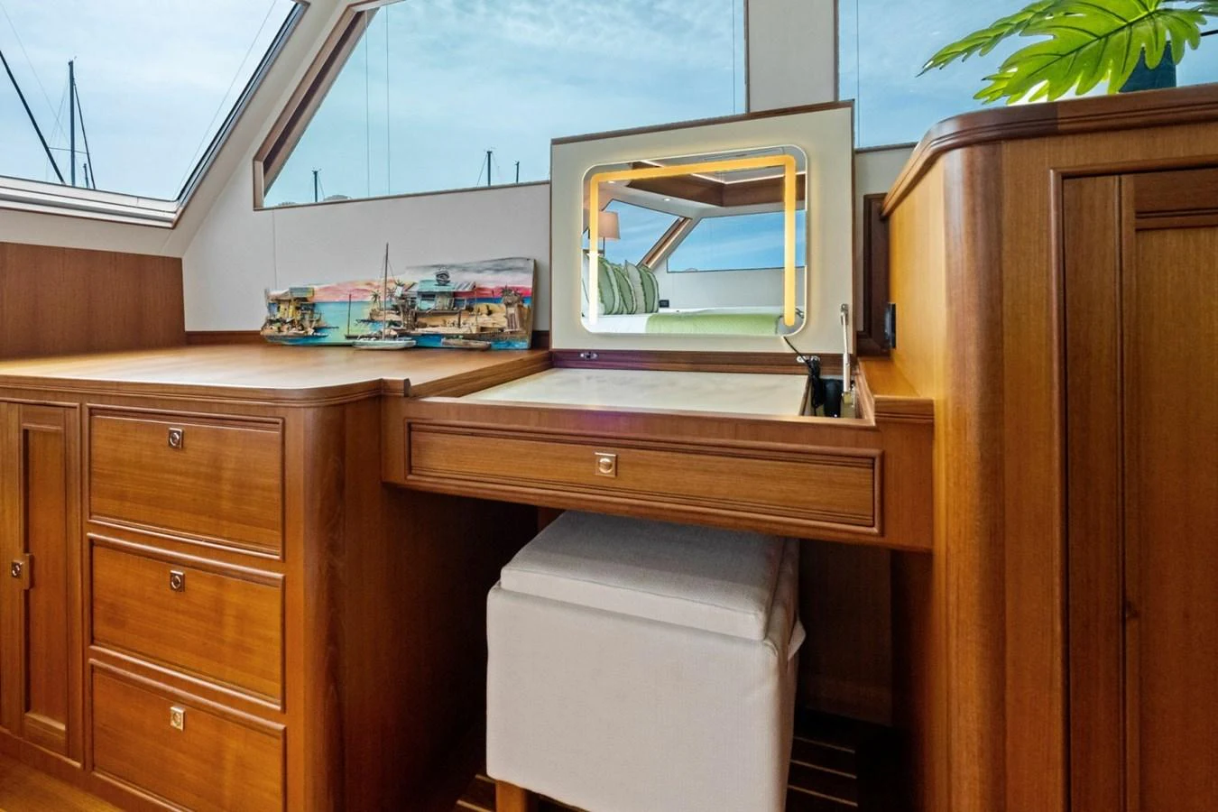 The yacht's interior features a wooden vanity area with a mirror and a model ship display. aboard ARTEMIS II Yacht for Sale