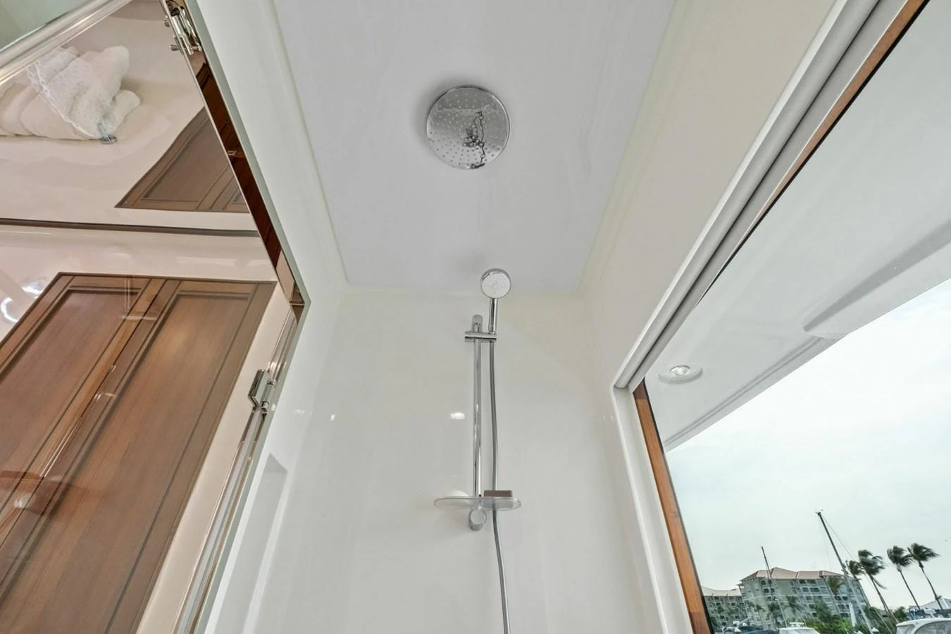 A modern yacht shower with a sleek design and a view of the marina. aboard ARTEMIS II Yacht for Sale