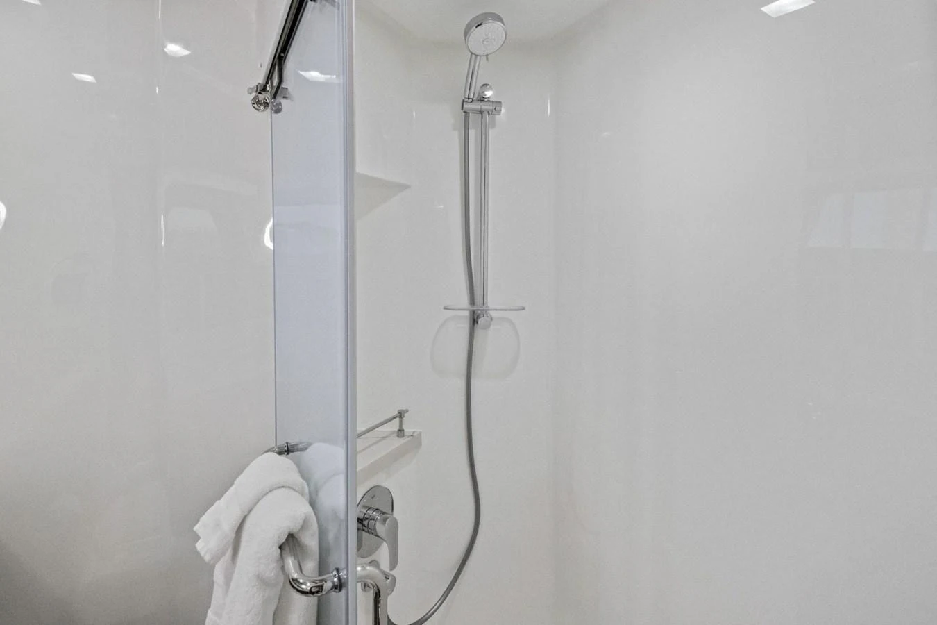 The yacht features a sleek and modern shower area with a minimalist design. aboard ARTEMIS II Yacht for Sale