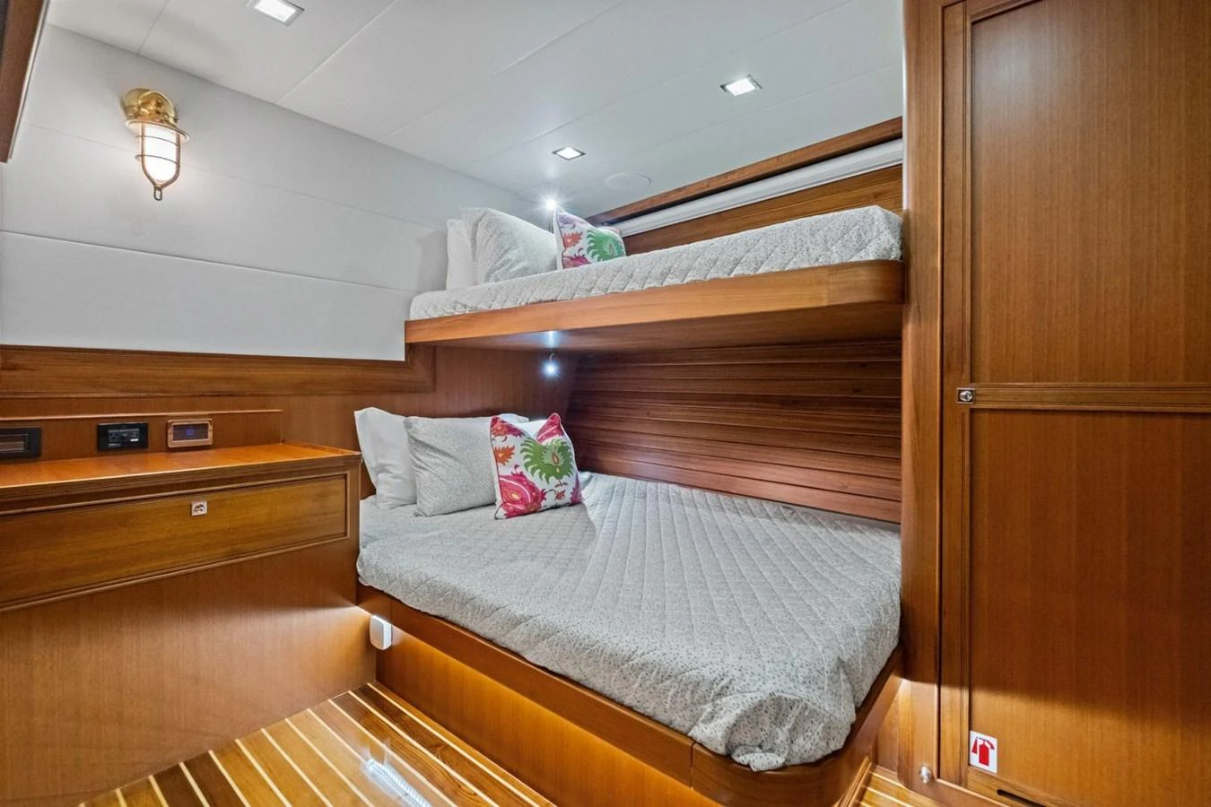 A cozy guest cabin featuring wooden finishes and comfortable bunk beds. aboard ARTEMIS II Yacht for Sale
