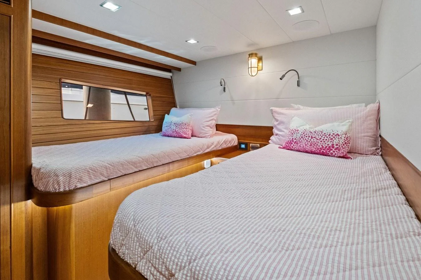 The guest cabin features two comfortable twin beds with soft lighting and wooden accents. aboard ARTEMIS II Yacht for Sale