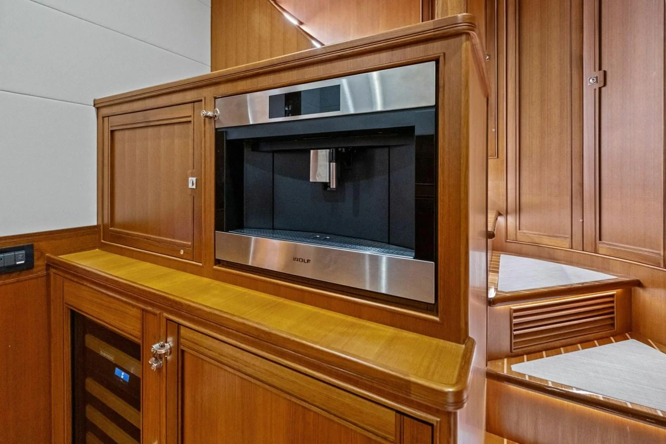 The galley features a built-in coffee machine and ample wooden cabinetry. aboard ARTEMIS II Yacht for Sale