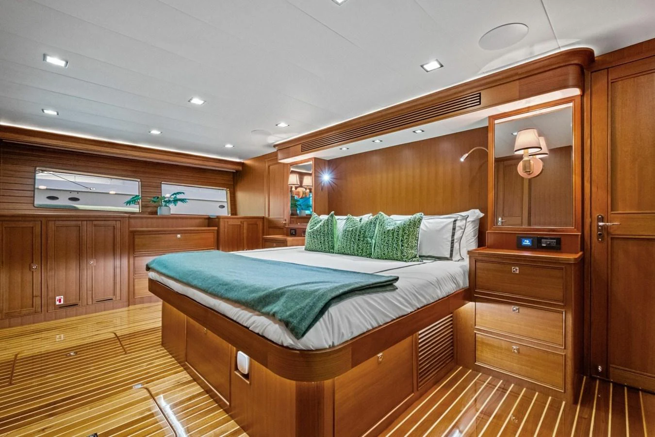 The master stateroom features a spacious bed with elegant wood paneling and modern lighting. aboard ARTEMIS II Yacht for Sale