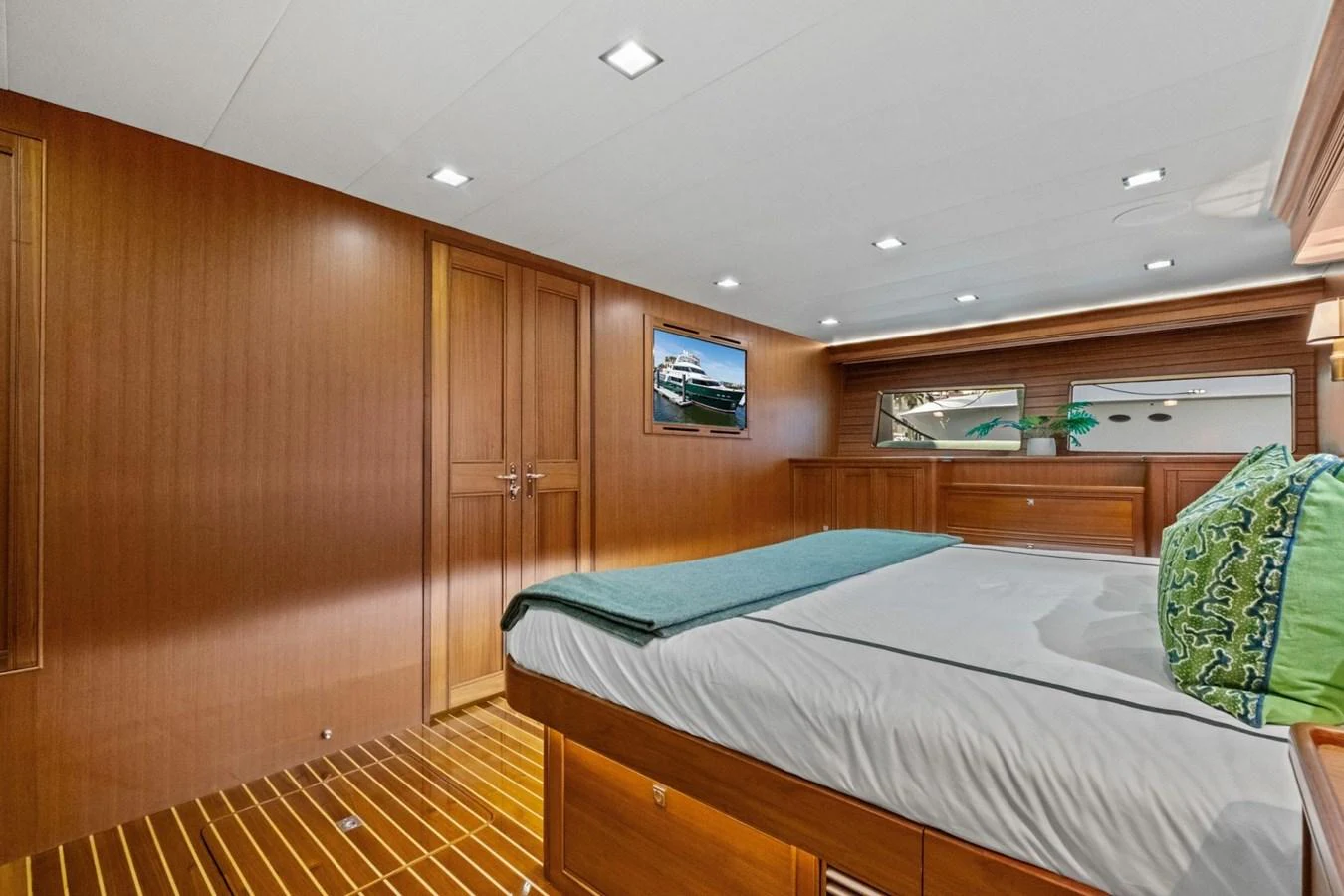 The stateroom features elegant wood paneling and a comfortable bed with luxurious bedding. aboard ARTEMIS II Yacht for Sale