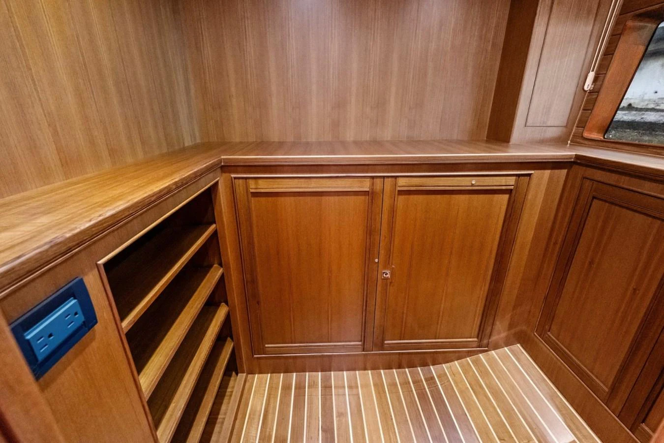 The image showcases a wooden interior space with cabinetry and shelving, highlighting the yacht's craftsmanship. aboard ARTEMIS II Yacht for Sale