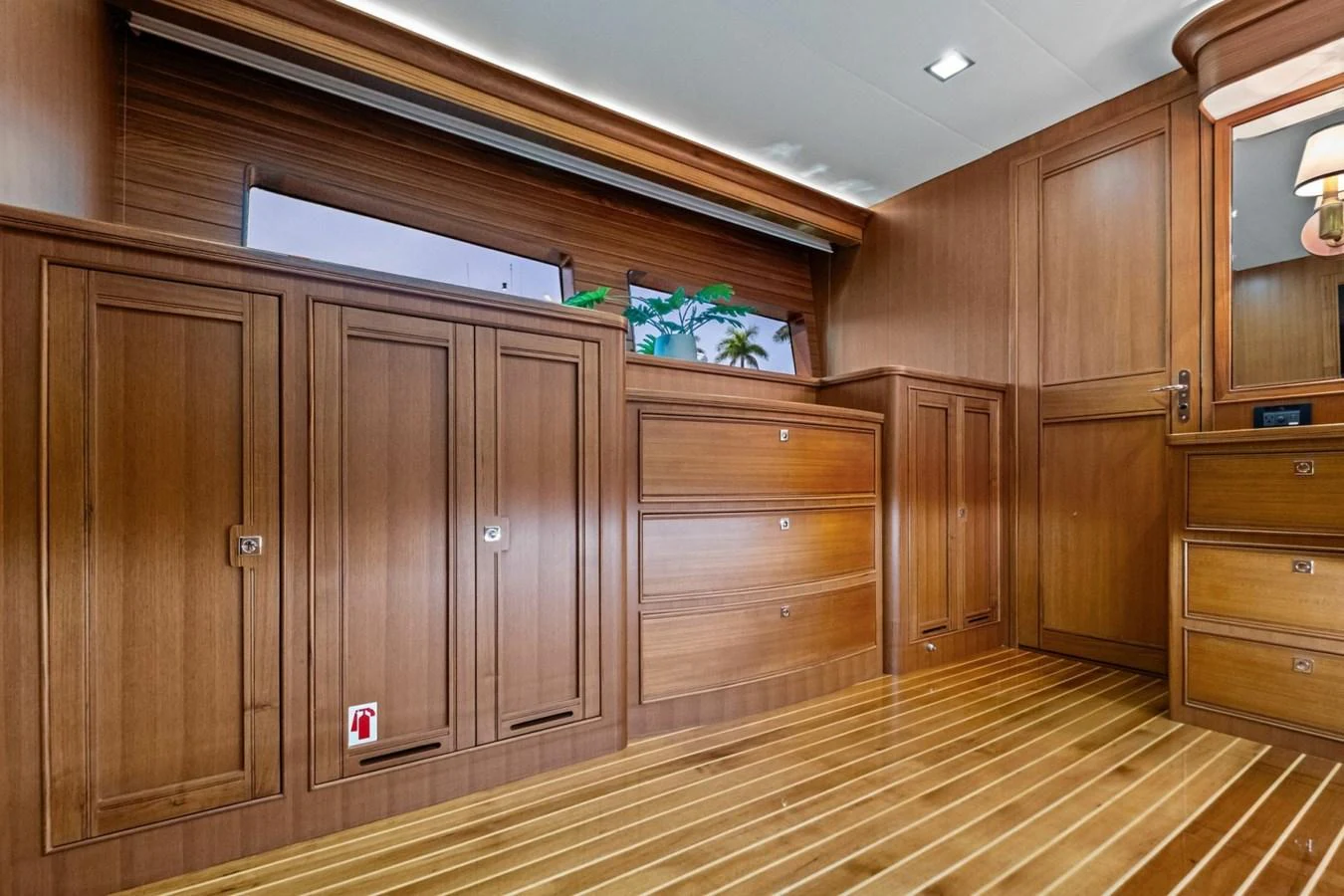 The yacht's interior features elegant wooden cabinetry and flooring, creating a warm and inviting atmosphere. aboard ARTEMIS II Yacht for Sale