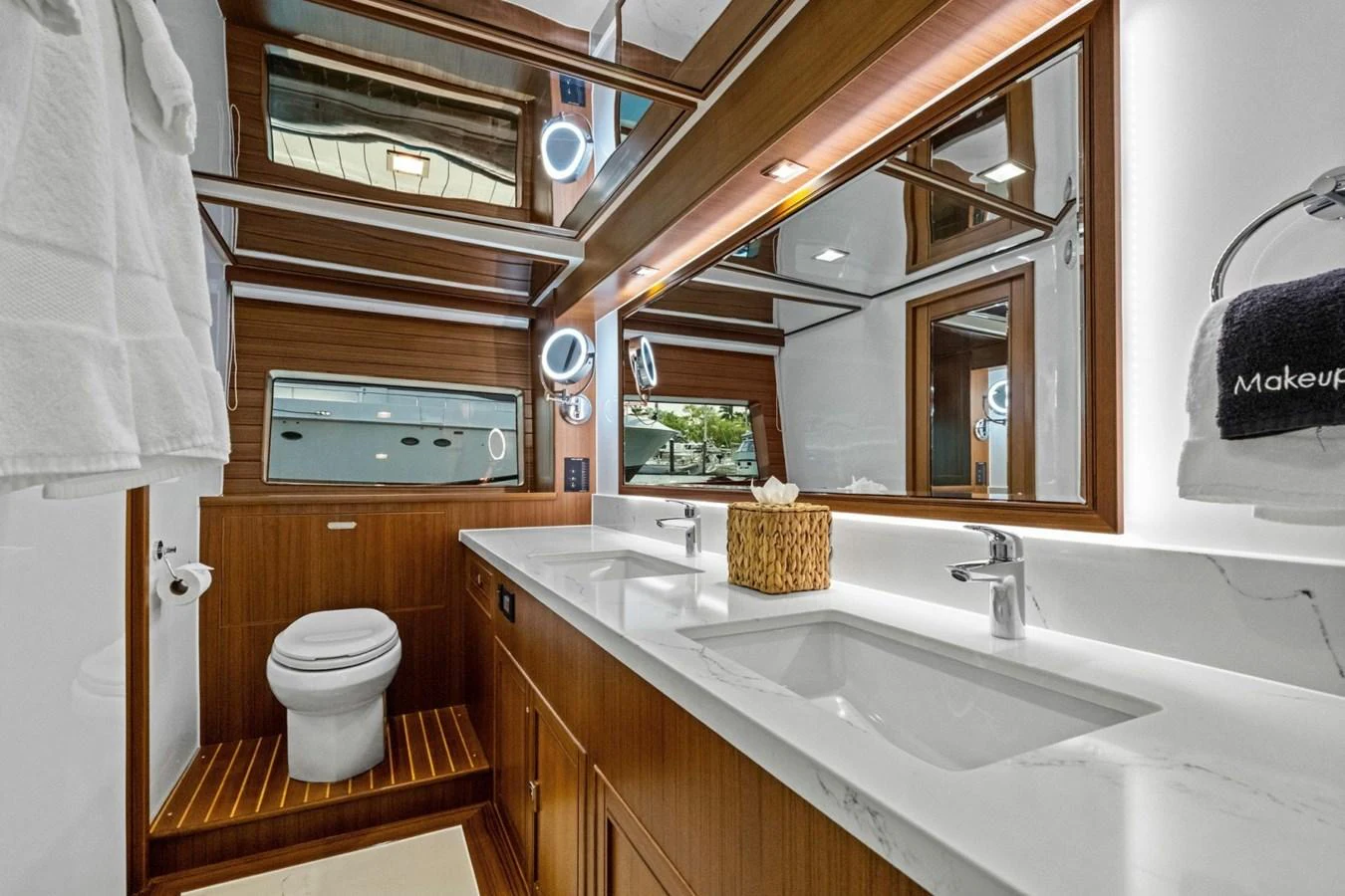 The yacht's bathroom features elegant wood paneling, dual sinks, and a spacious layout. aboard ARTEMIS II Yacht for Sale